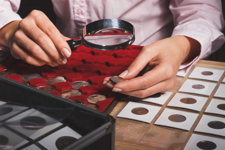 coin collector examining one of her coin collections