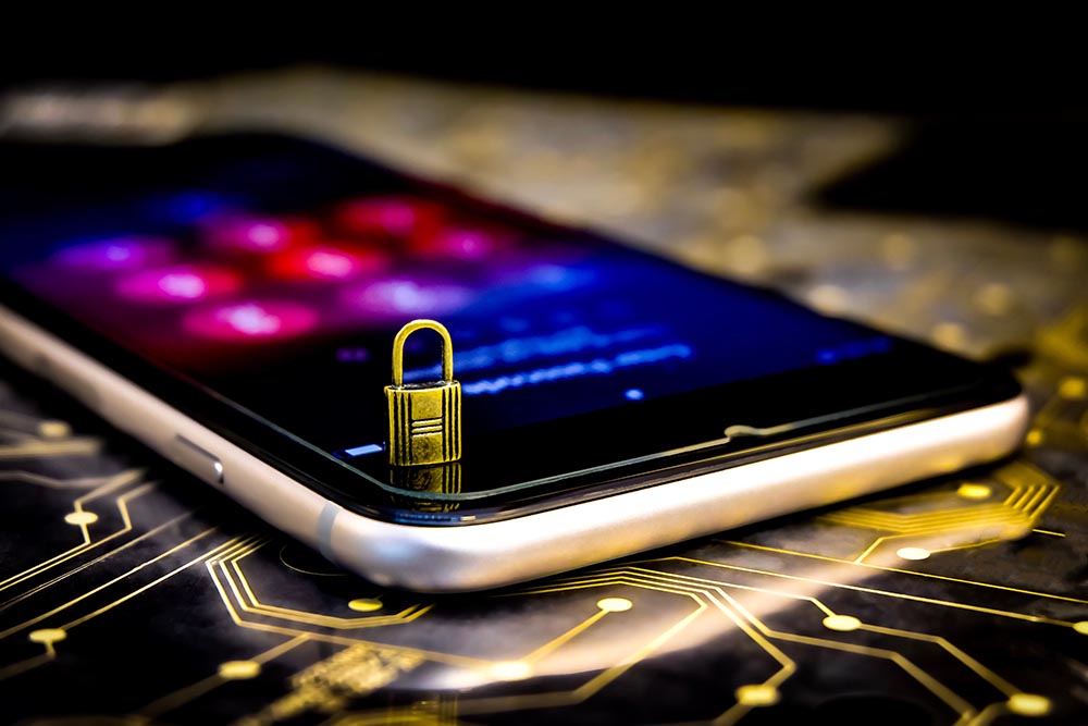 a tiny padlock standing on top of a mobile phone