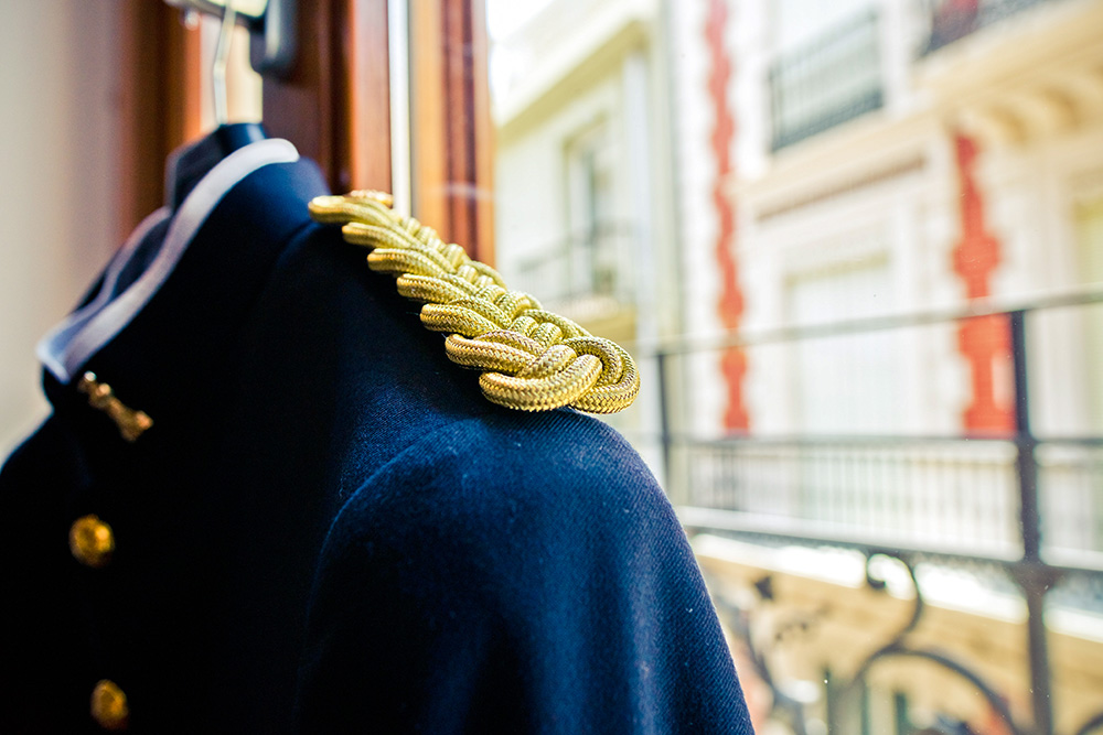 Detail of the embroidered golden insignia of a dark blue militar